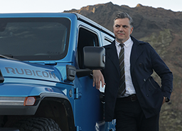 Blue Jeep wrangler with a man